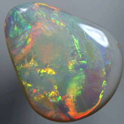 SOLID SEMI BLACK OPAL Large opal with rolling flasehs of orange SEE VIDEO